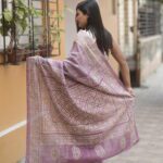 Mauve Tussar silk saree with beige Gujarati embroidery.