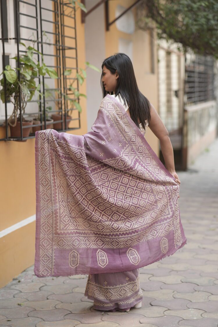 Mauve Tussar silk saree with beige Gujarati embroidery.