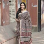 Hand block printed Beige with Maroon jaal print Maheshwari saree showcasing Bagh motifs