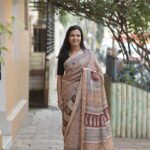 Beige Maheshwari saree featuring an all-over Chrome Yellow and Maroon floral Jal Bagh hand-block print.