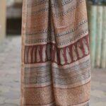 Elegant pallu of a Beige Maheshwari saree showcasing traditional Bagh block print borders and Chrome Yellow accents.