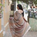 Elegant pallu of a Beige Maheshwari saree showcasing traditional Bagh block print borders and Chrome Yellow accents.