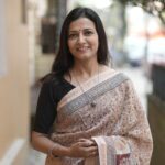 Detailed view of the intricate Maroon and Yellow Jal motifs on the sheer texture of a Beige Maheshwari handloom saree.