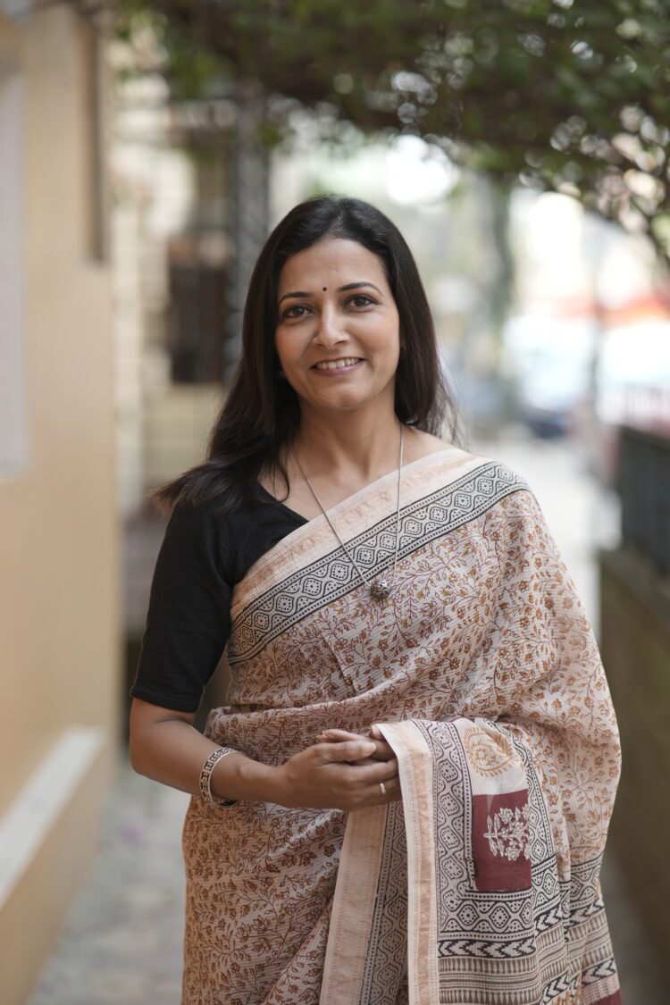 Detailed view of the intricate Maroon and Yellow Jal motifs on the sheer texture of a Beige Maheshwari handloom saree.