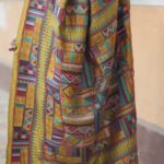 Close-up of multicolour geometric Kantha hand embroidery on chrome yellow saree