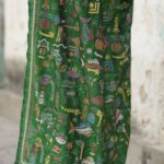Close-up of Kantha hand embroidery on green silk saree showing dense diagonal stitch work from pallu area.