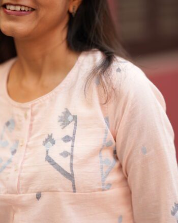 Close-up of Jamdani weaving on peach cotton top